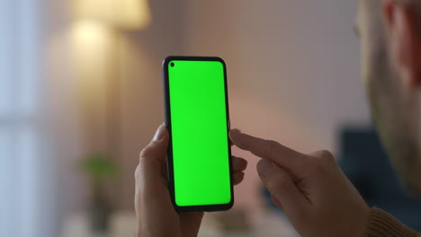 man-is-using-new-application-in-modern-smartphone-with-green-screen-for-chroma-key-montage-closeup-view-of-fingers-swiping-and-pressing-sensor-display